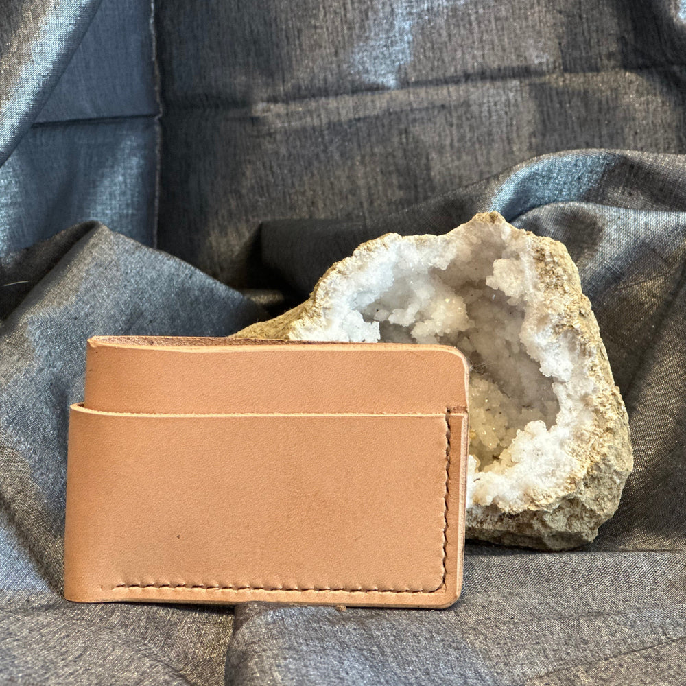 Veg Tan Horizontal Wallet is handmade with high quality top grain solid leather.  It is a slim fit wallet designed to carry your essentials and is constructed to last, endure, and abide.  Cards slide in and out horizontally and are oriented similarly to landscape mode on your phone.