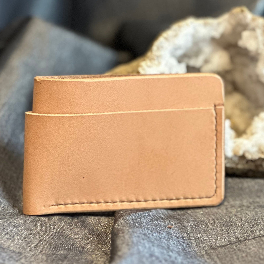 Veg Tan Horizontal Wallet is handmade with high quality top grain solid leather.  It is a slim fit wallet designed to carry your essentials and is constructed to last, endure, and abide.  Cards slide in and out horizontally and are oriented similarly to landscape mode on your phone.