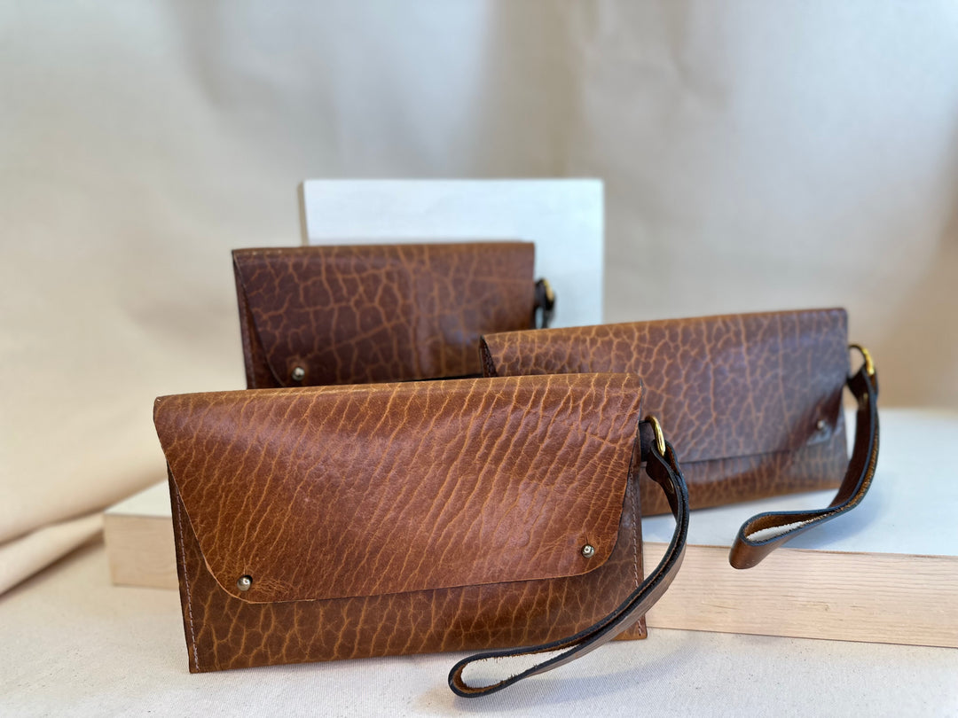 Our Glazed Bison Handstitched Leather Clutch offers a classic, stylish look that's built to last. Crafted with solid, top grain leather, this clutch wallet is perfect for holding all your everyday essentials. Enjoy clean, simple design lines with this shop favorite.