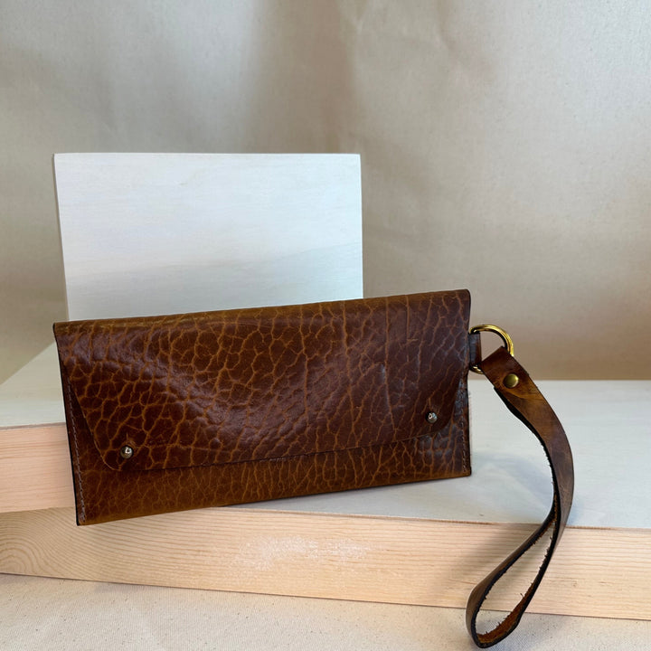 Our Glazed Bison Handstitched Leather Clutch offers a classic, stylish look that's built to last. Crafted with solid, top grain leather, this clutch wallet is perfect for holding all your everyday essentials. Enjoy clean, simple design lines with this shop favorite.