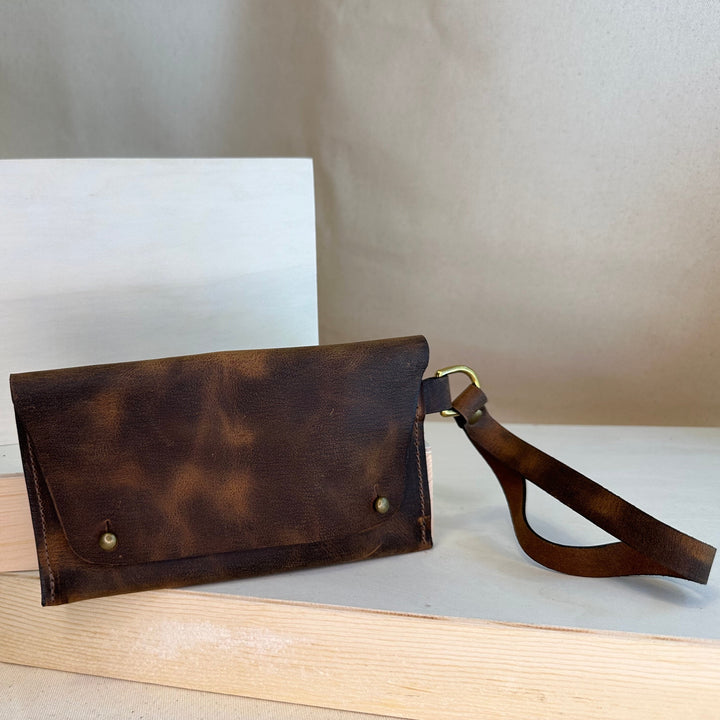 Our Brown Pull Up Handstitched Leather Clutch offers a classic, stylish look that's built to last. Crafted with solid, top grain leather, this clutch wallet is perfect for holding all your everyday essentials. Enjoy clean, simple design lines with this shop favorite.