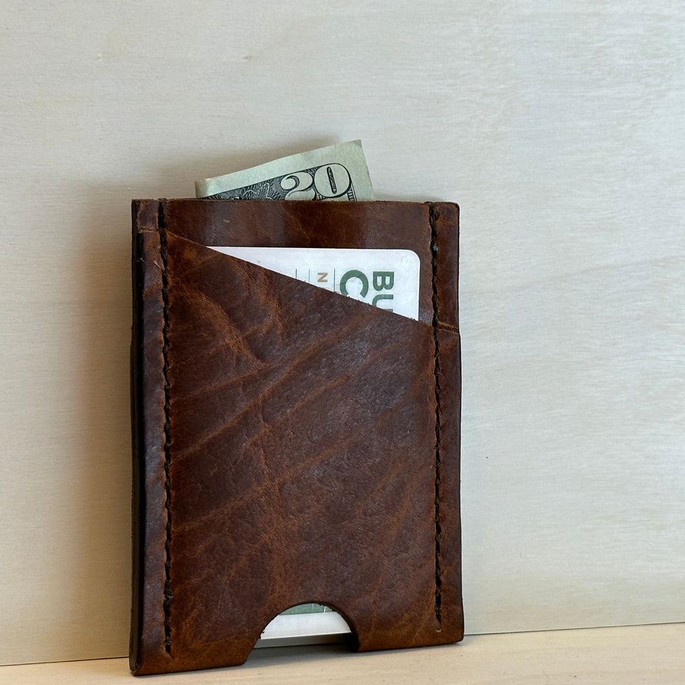 Our Glazed Bison Vertical Wallet is handmade with high quality top grain solid leather.  It is a slim fit wallet designed to carry your essentials and is constructed to last, endure, and abide.  Cards slide in and out vertically and are oriented similarly to portrait mode on your phone.