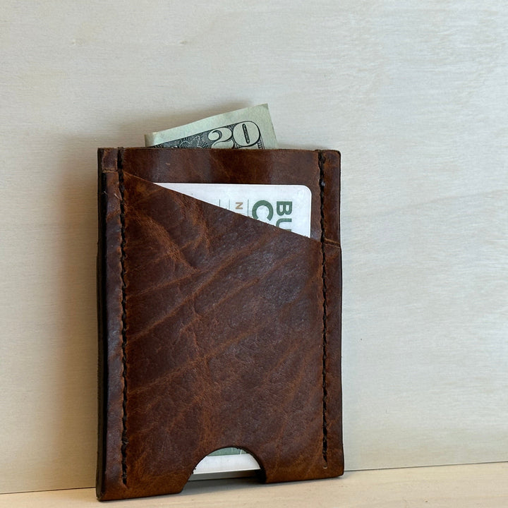 Our Glazed Bison Vertical Wallet is handmade with high quality top grain solid leather.  It is a slim fit wallet designed to carry your essentials and is constructed to last, endure, and abide.  Cards slide in and out vertically and are oriented similarly to portrait mode on your phone.