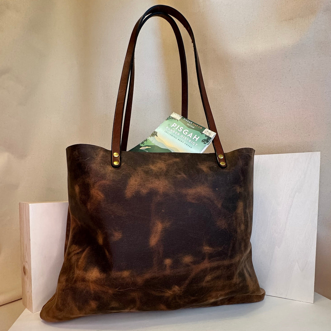 Our Everyday Carry Medium Brown Pull Up Leather Tote Bag is a tactical, practical style move.  Shining Rock Goods crafts each and every bag in our Asheville, NC studio.  Our tote bags are made of USA tanned, solid, top grain, high quality, supple leather. portfolio