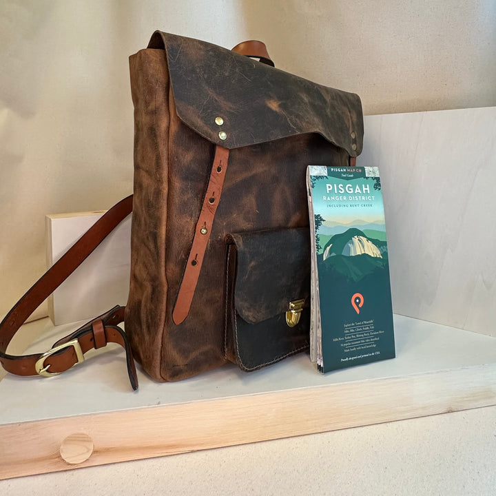 The Shining Rock Goods Tech Companion Brown Pull Up Leather Backpack is handmade in our Asheville, NC Studio.  It is made from high quality, USA tanned solid top grain leather with solid brass hardware. This bag can transport your tech to the next dimension or alternate reality, or at the very least from the car to the office.  Or the couch to the cafe.  Or the bus to the classroom. The brown pull up is the perfect color to pull off the Kessel Run in less than 12 parsecs- but you didn't hear it from us!