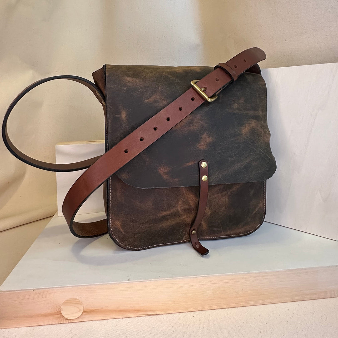 Our Brown Pull Up Forager Mini Cross Body Leather Bag is handmade out of a beautiful top grain leather with an outside stitch and a structured design.  Inspired by those who like to protect what they collect as they move about the world, its timeless style will suit your needs whether you like to hunt or gather. 