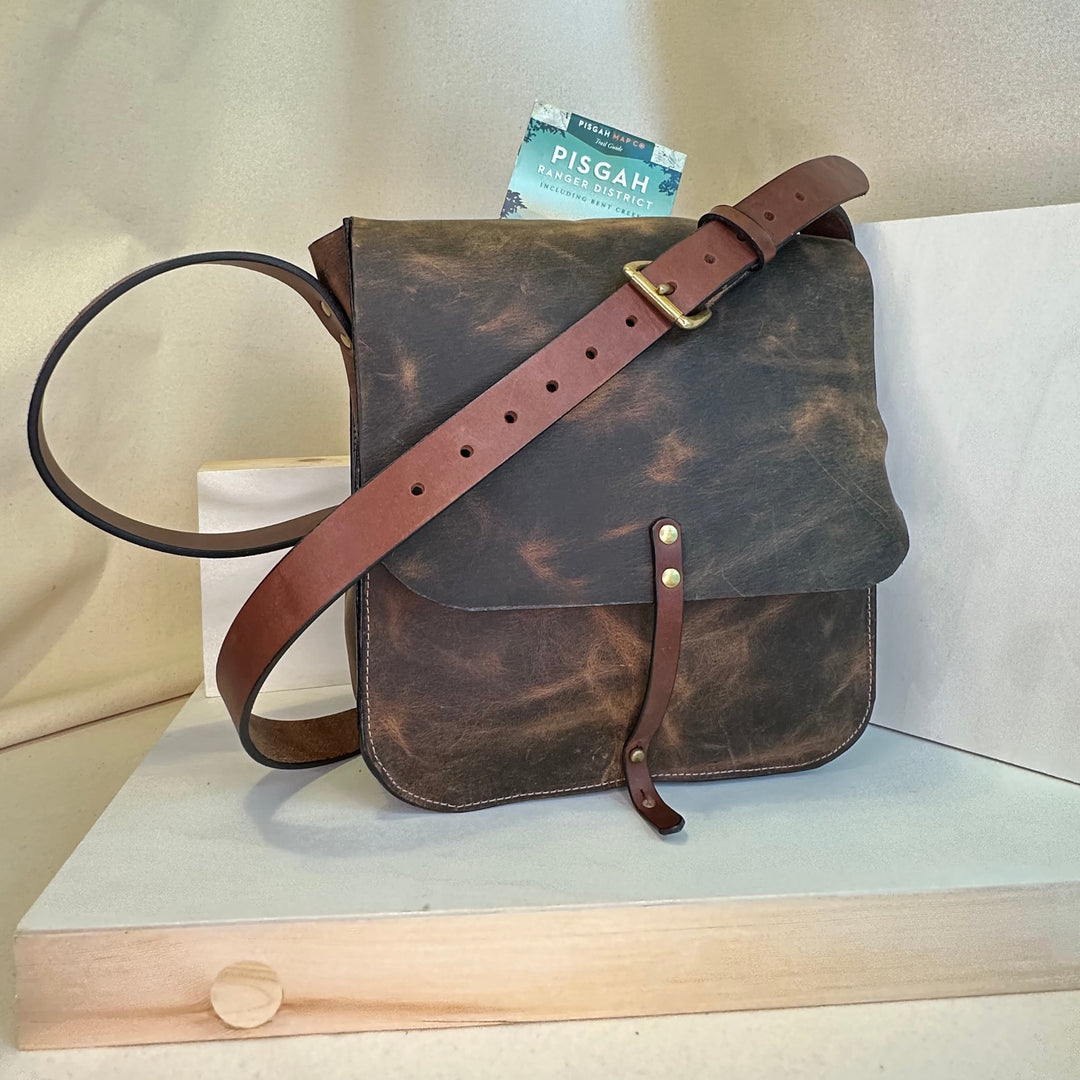 Our Brown Pull Up Forager Mini Cross Body Leather Bag is handmade out of a beautiful top grain leather with an outside stitch and a structured design.  Inspired by those who like to protect what they collect as they move about the world, its timeless style will suit your needs whether you like to hunt or gather. 