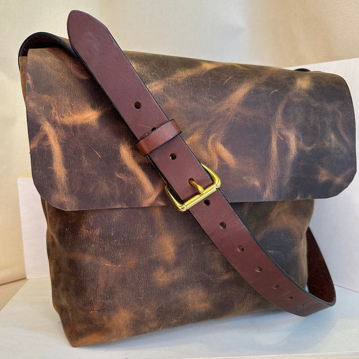 Shining Rock Goods Hand Stitched Brown Pull Up Leather Messenger Bag helps you get your message across loud and clear.  This messenger bag conveys impeccable style, accountability, durability, reliability, and investment.  Made of the finest quality, top grain solid leather with hand stitched seams and solid nickle silver.  This bag makes an excellent rite of passage gift to yourself or someone who has worked hard to acheive a goal, and has even more gratifying work ahead on their journey.