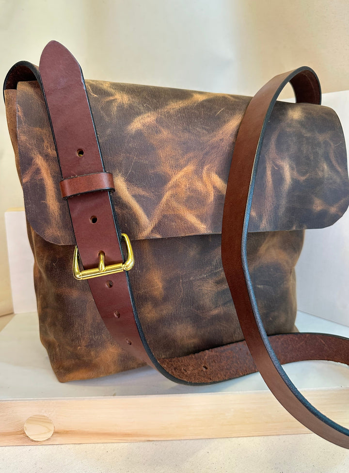 Shining Rock Goods Hand Stitched Brown Pull Up Leather Messenger Bag helps you get your message across loud and clear.  This messenger bag conveys impeccable style, accountability, durability, reliability, and investment.  Made of the finest quality, top grain solid leather with hand stitched seams and solid nickle silver.  This bag makes an excellent rite of passage gift to yourself or someone who has worked hard to acheive a goal, and has even more gratifying work ahead on their journey.