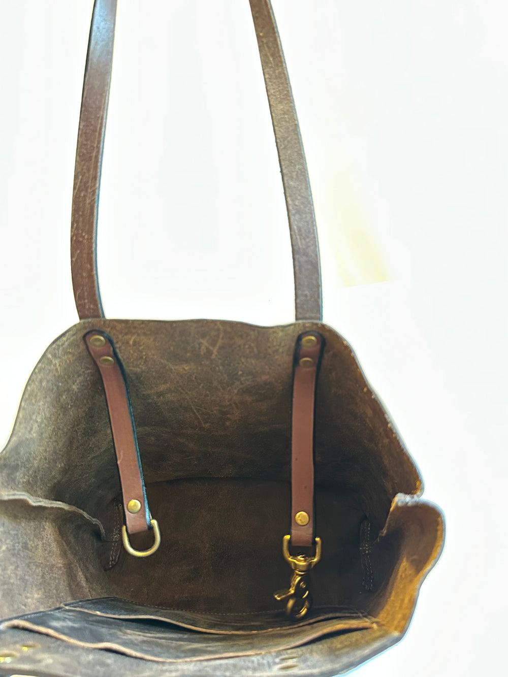 Our handmade Brown Pull Up EDC Mini Leather Tote Bag is hand crafted in our Asheville, NC studio.  It is our compact tote that can carry anything from top secret dossiers to mini bottles for apres-anything.  Made from the highest quality top grain, solid leather, this bag will outlast your sister's second and third marriages.