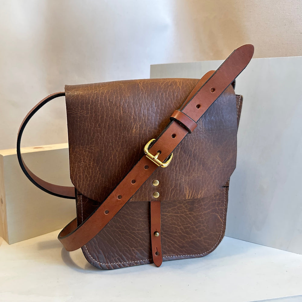Our Glazed Bison Forager Mini Crossbody Leather Bag is handmade out of a beautiful top grain leather with an outside stitch and a structured design.  Inspired by those who like to protect what they collect as they move about the world, its timeless style will suit your needs whether you like to hunt or gather. 