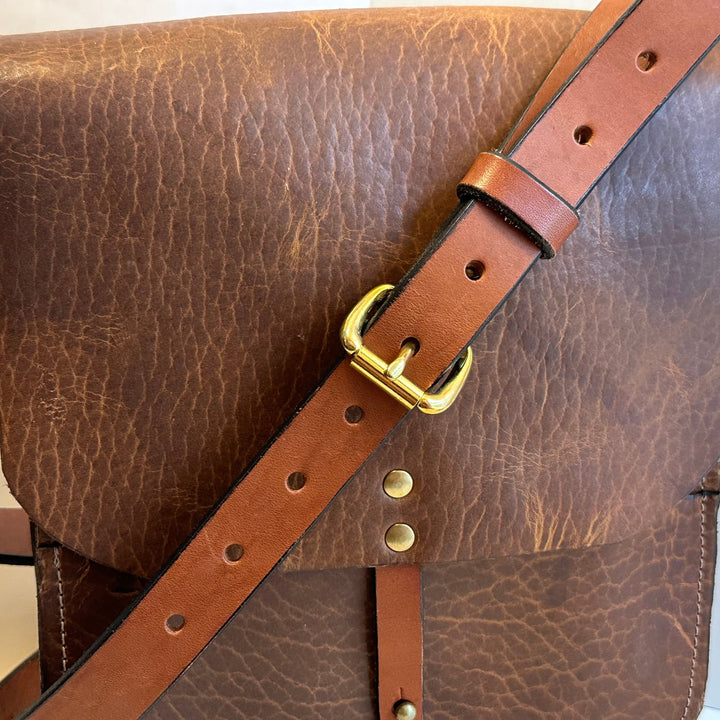 Our Glazed Bison Forager Mini Crossbody Leather Bag is handmade out of a beautiful top grain leather with an outside stitch and a structured design.  Inspired by those who like to protect what they collect as they move about the world, its timeless style will suit your needs whether you like to hunt or gather. 