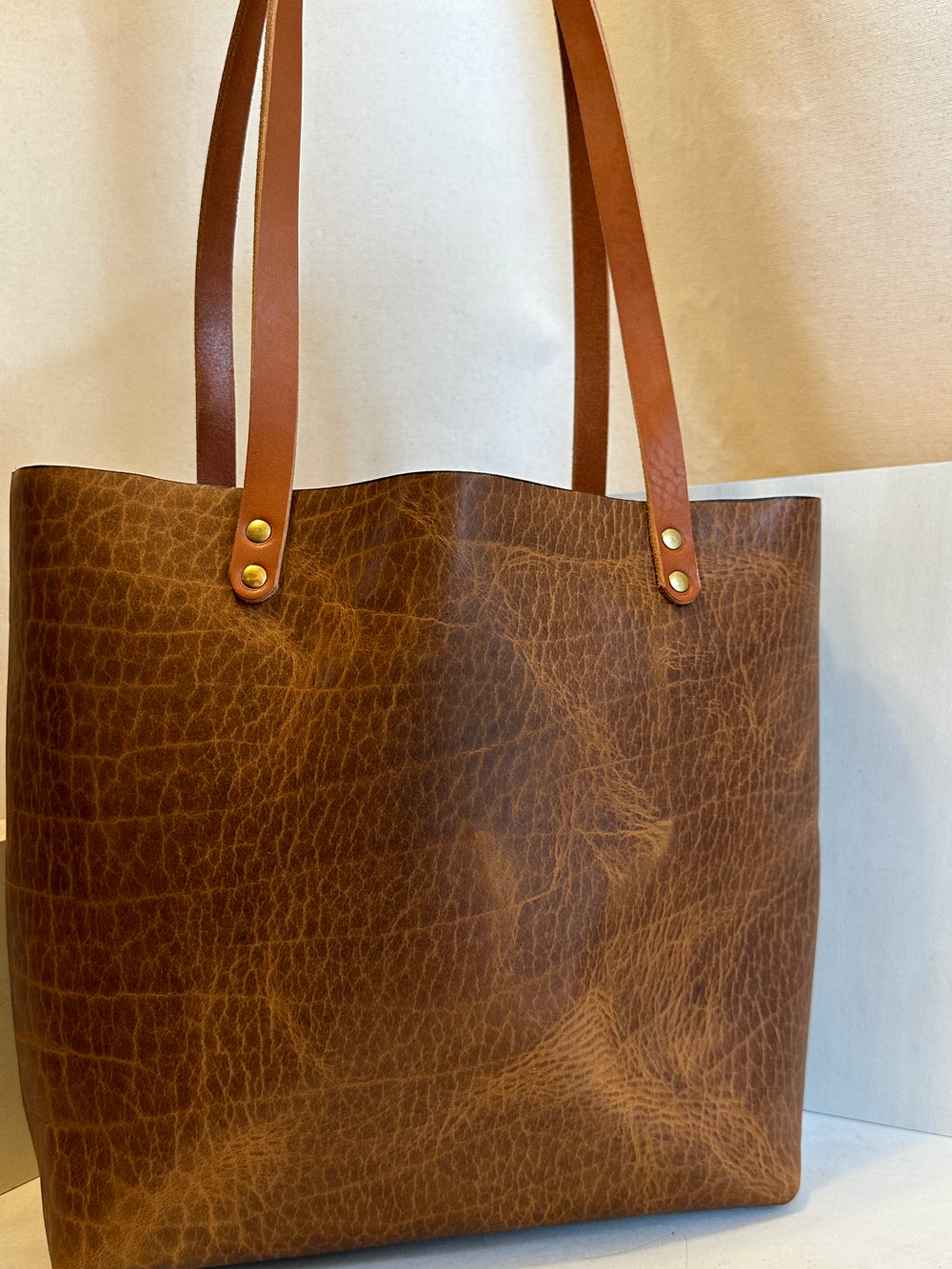 Our handmade Everyday Carry Large Glazed Bison Leather Tote Bag is a work of art, work horse, workin' it kinda bag.  Crafted from the highest quality, USA tanned, solid, top grain leather