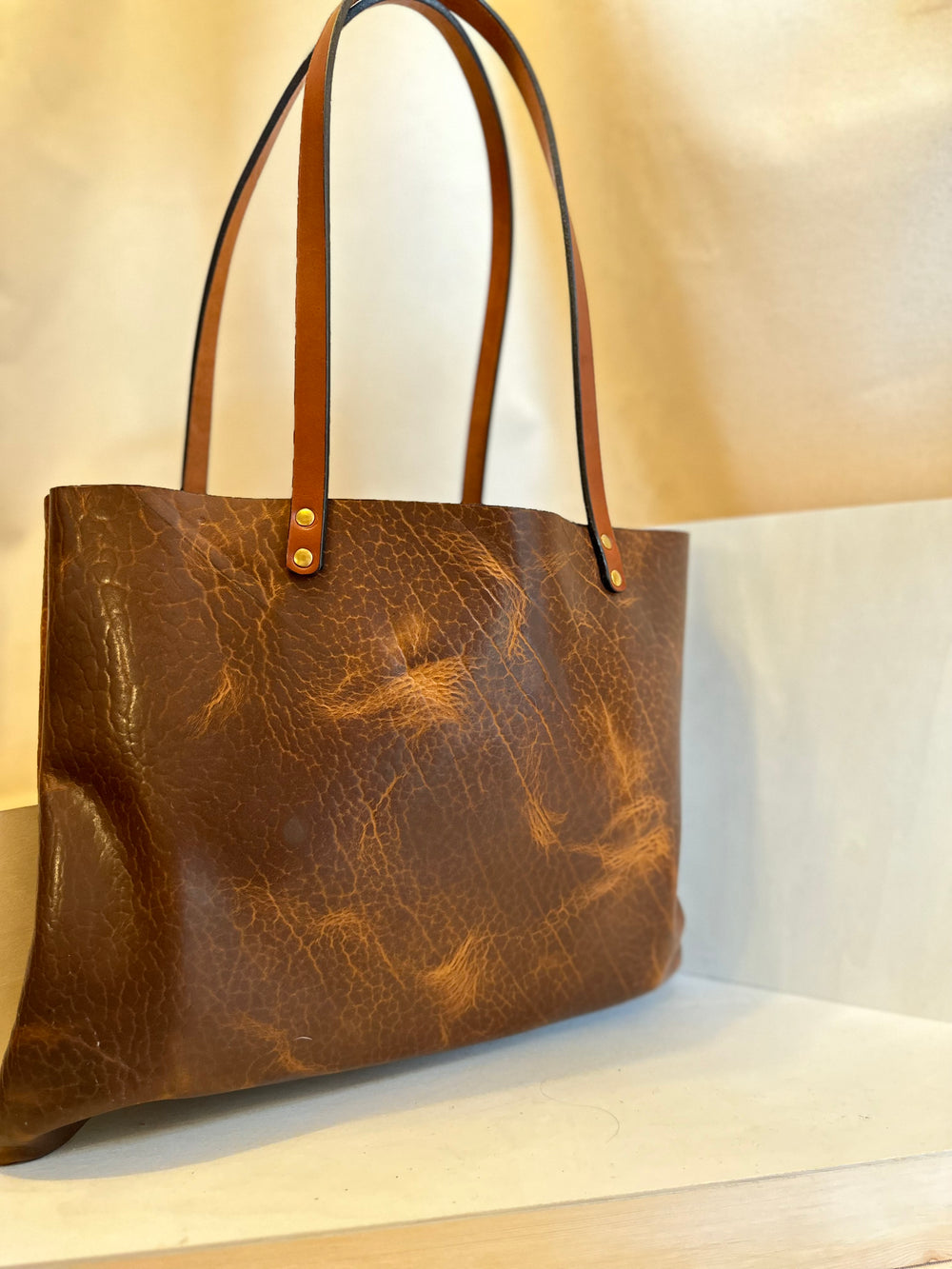 Shining Rock Goods crafts each and every bag in our Asheville, NC studio.  Our tote bags are made of USA tanned, solid, top grain, high quality, supple leather.  This bag will stand the test of time, more than normal wear and tear; it shows up and shows out.