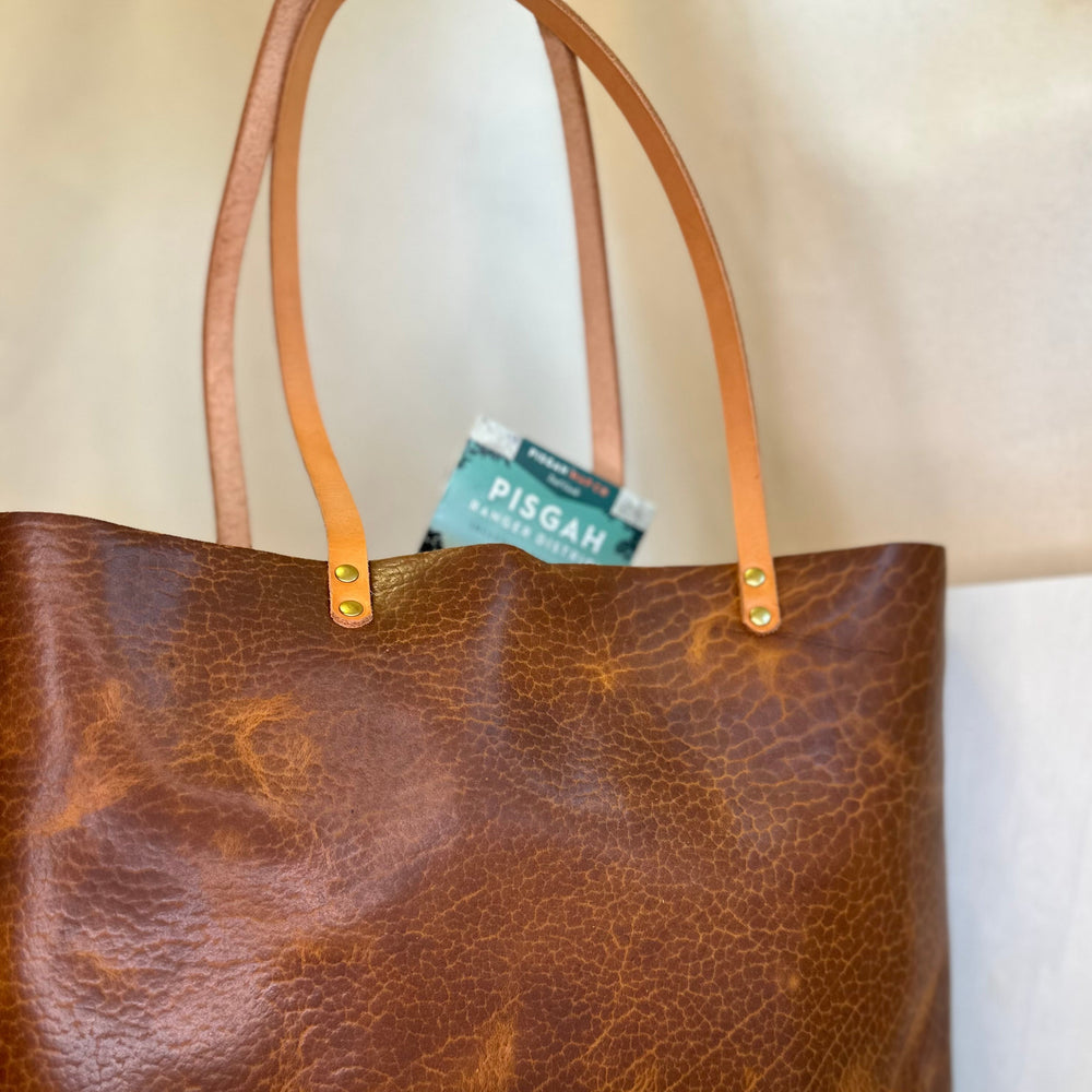 The Shining Rock Goods First Class LX Glazed Bison Leather Tote Bag is crafted from top grain, USA tanned leather, it is designed for maximum longevity and the quietest of luxury.