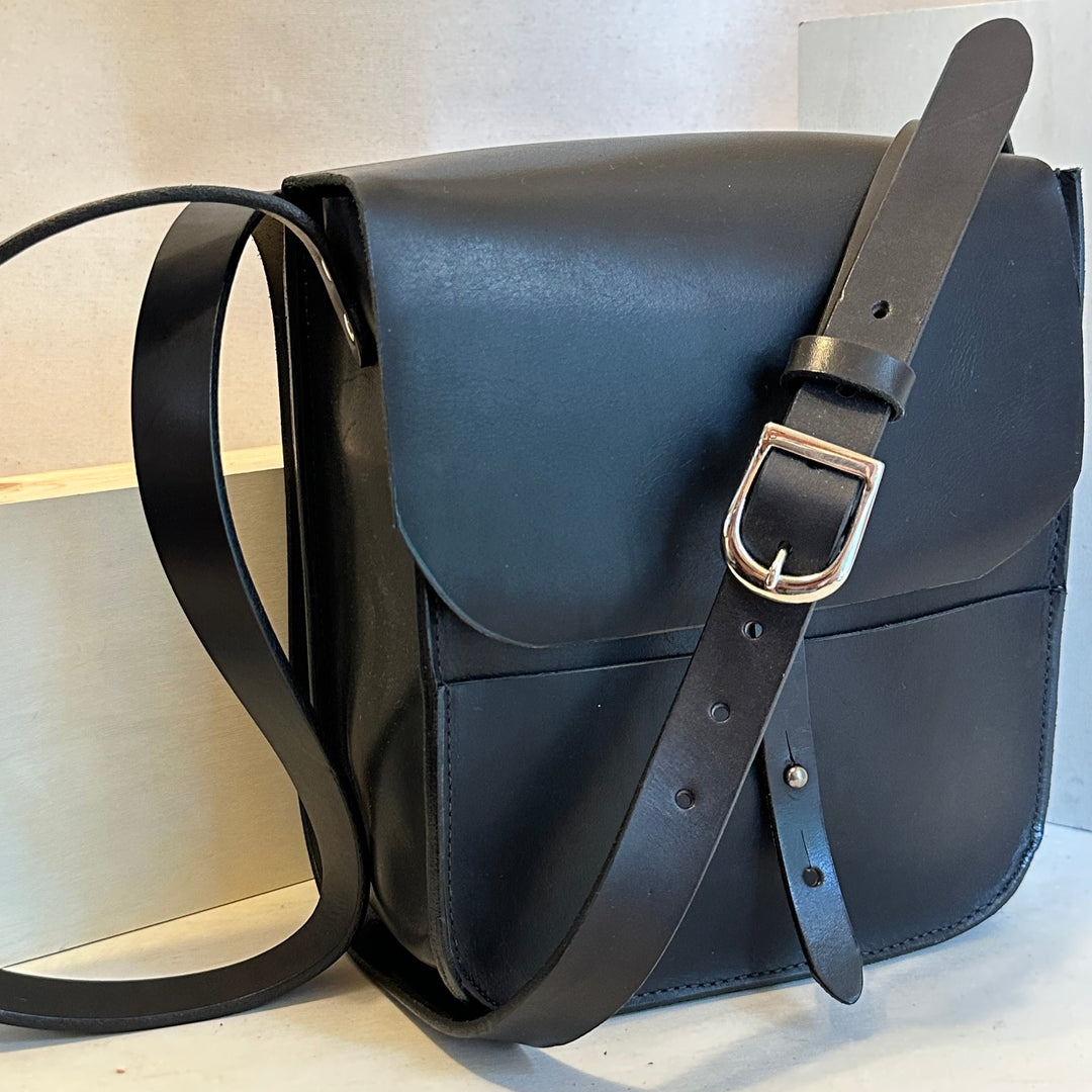 Our Black Forager Mini Cross Body Leather Bag is handmade out of Horween chrome XL top grain leather with an outside stitch and a structured design.  Inspired by those who like to protect what they collect as they move about the world, its timeless style will suit your needs whether you like to hunt or gather. 