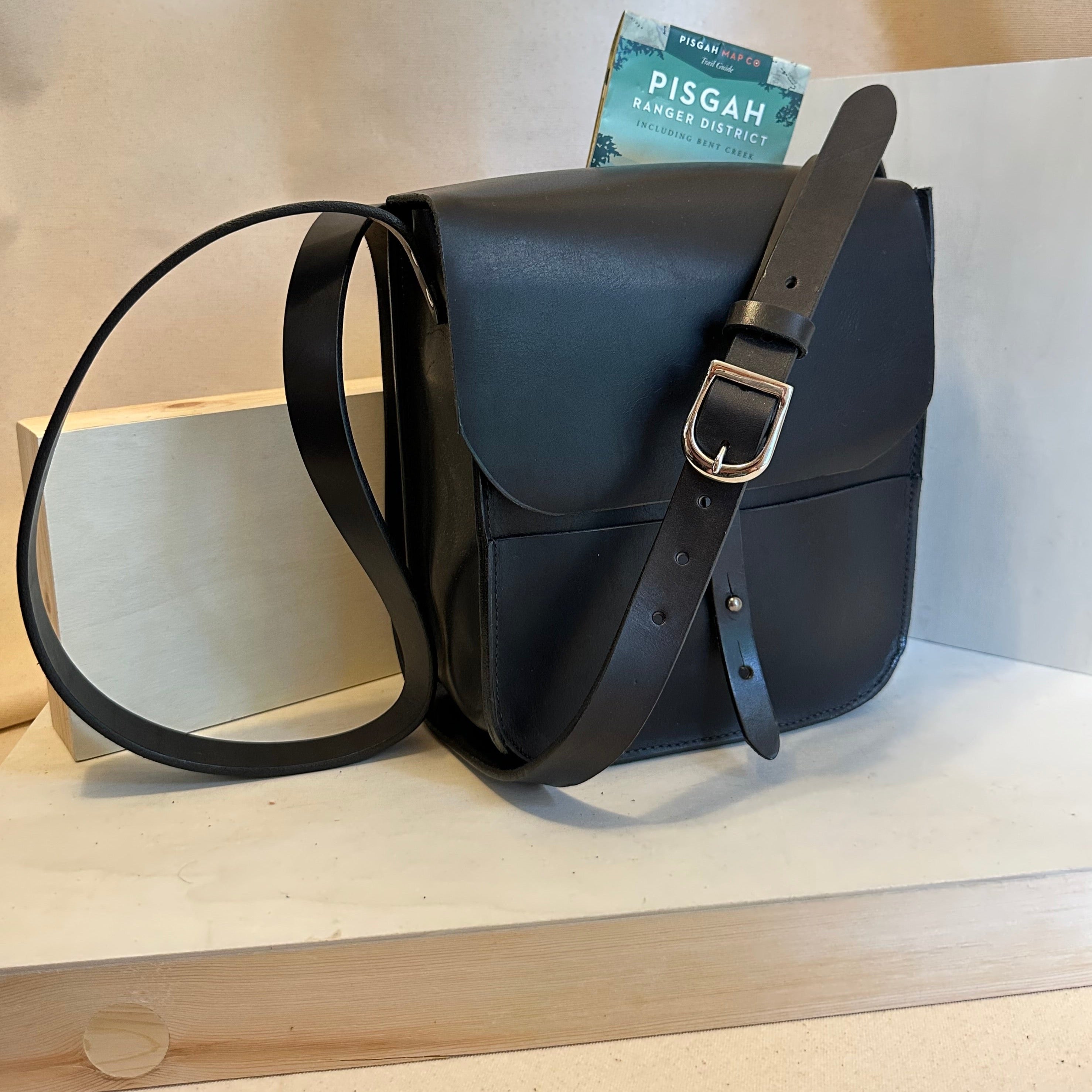 Our Black Forager Mini Cross Body Leather Bag is handmade out of Horween chrome XL top grain leather with an outside stitch and a structured design.  Inspired by those who like to protect what they collect as they move about the world, its timeless style will suit your needs whether you like to hunt or gather. 