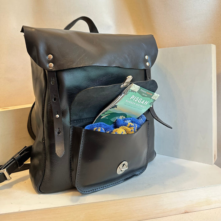 The Shining Rock Goods Tech Companion Black Leather Backpack is handmade in our Asheville, NC Studio.  It is made from high quality, USA tanned solid top grain leather.  This bag can transport your tech to the next dimension or alternate reality, or aat the very least from the car to the office.  Or the couch to the cafe.  Or the bus to the classroom. The black one is especially perfect for a Wednesday, but a Saturday, Sunday, or Bestie Enid might work too.Chrome xl cxl maine thread