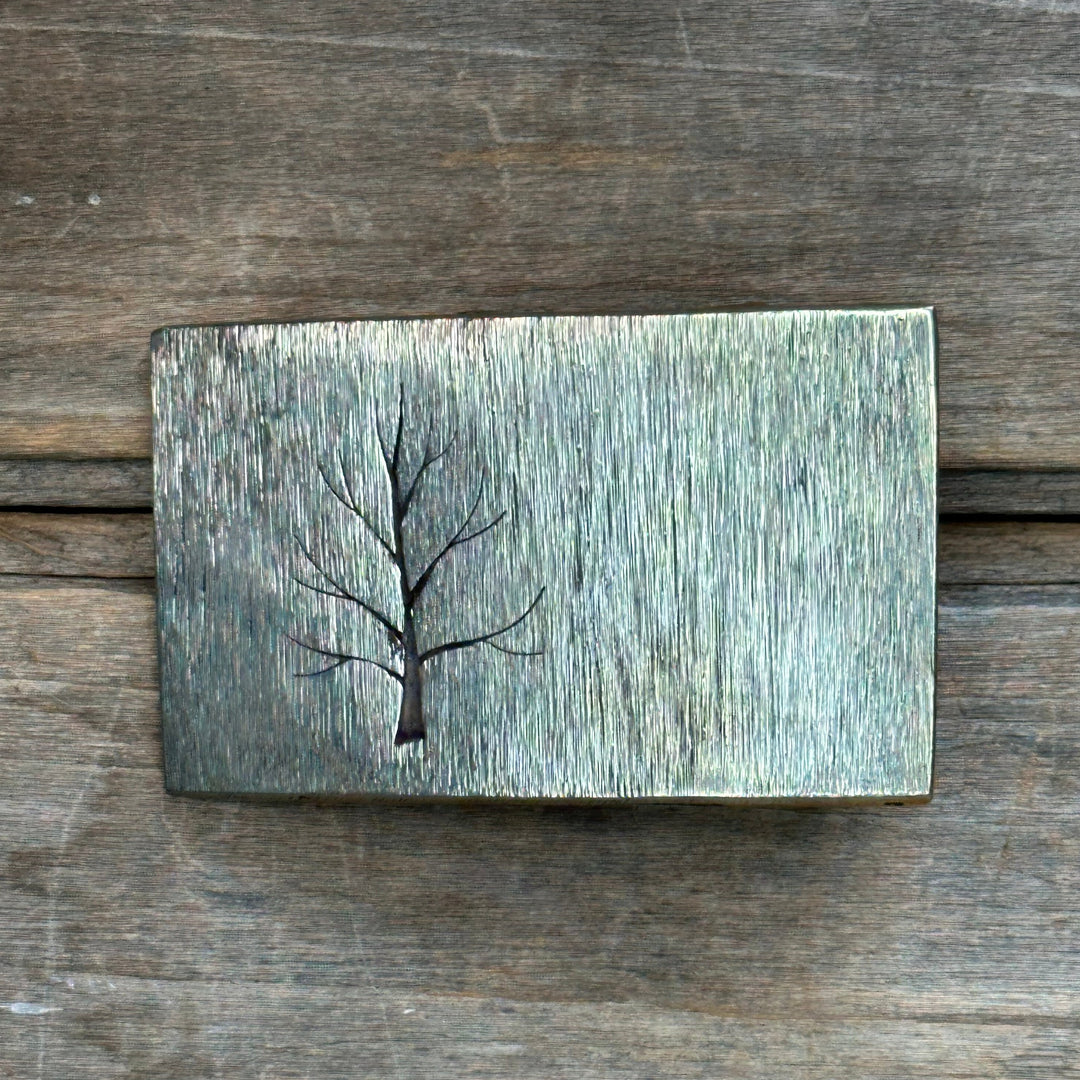 The "Tree" belt buckle by David M. Bowman is a timeless and durable design for those who wish to have a simple "go to" belt buckle to wear for any occasion.&nbsp; These belt buckles are handmade by David and his son Reed in their West Berkely, California studio.&nbsp; Each piece is handmade of solid nickel silver and textured with a grinder, providing a durable glinting effect.