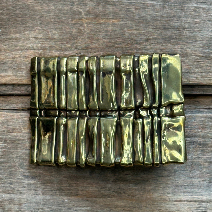 A solid brass handmade abstract "Spine" belt buckle by David M. Bowman.  Fits an inch and a quarter belt.