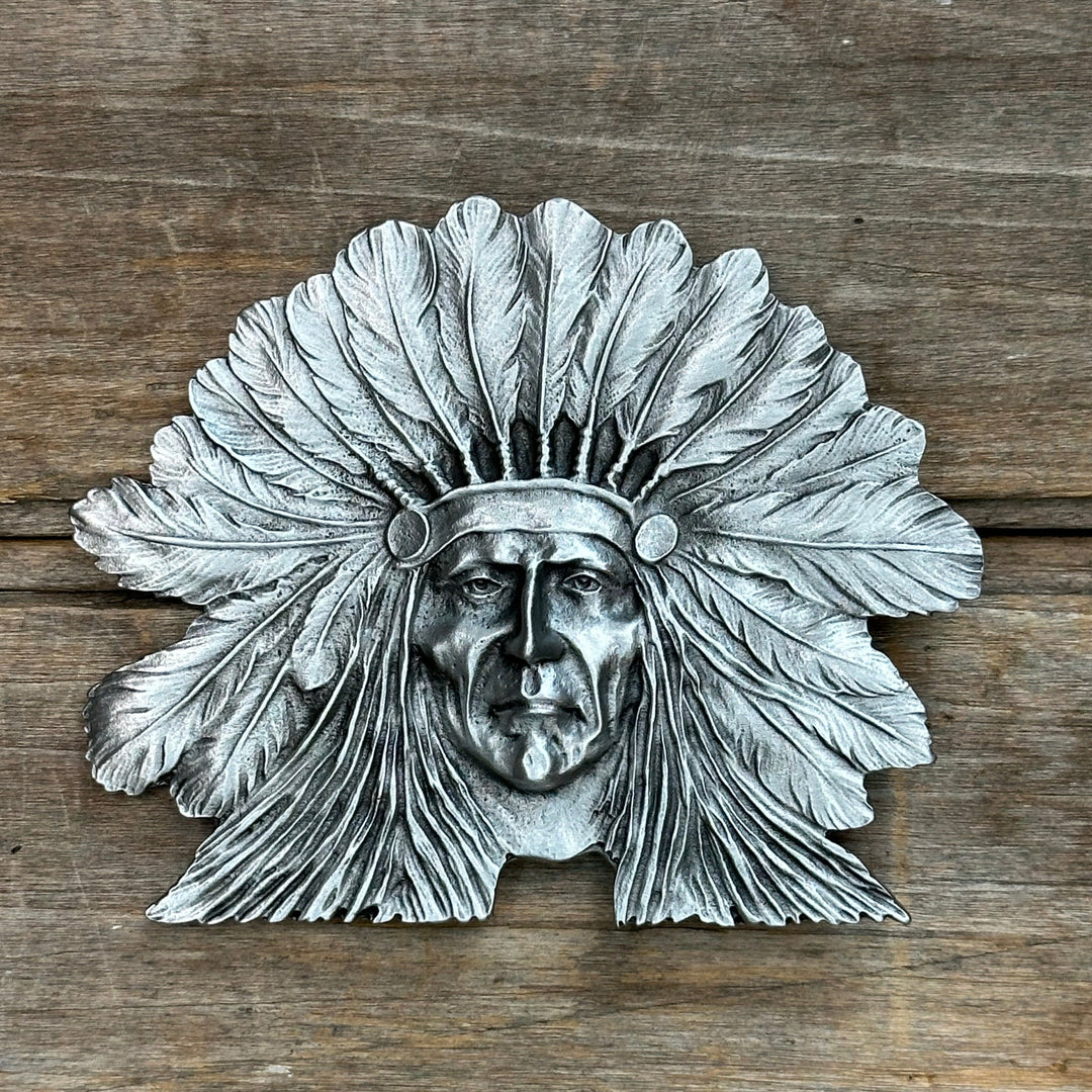 This is a pewter belt buckle with a silver tone.  It depicts a native american hero, sitting bull.