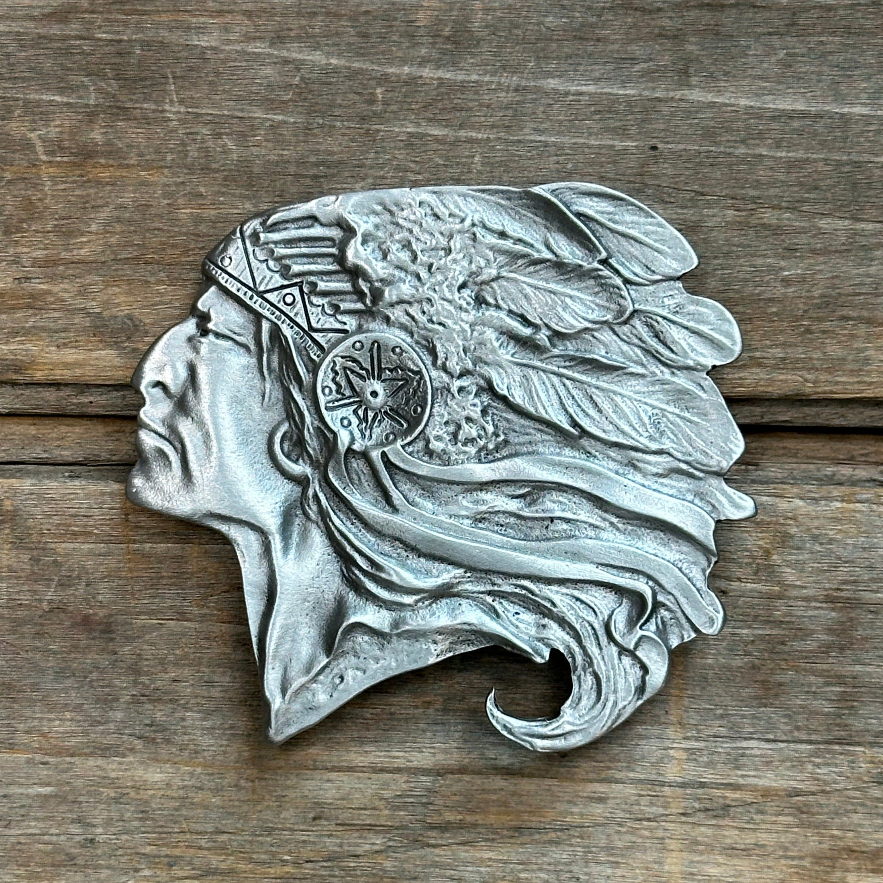 This is a pewter belt buckle with a silver tone.  It depicts a native american cheif pontiac in profile.
