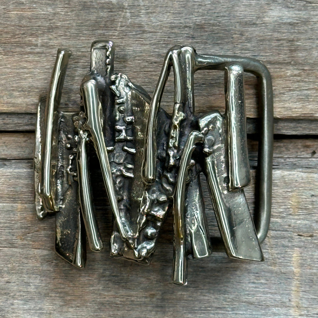 This is a solid brass belt buckle.  It is an abstract brutalist design with lots of texture.