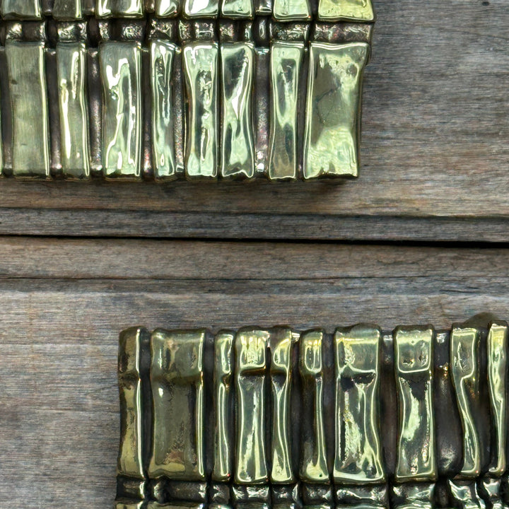Two brass abstract "Spine" belt buckles by David M. Bowman.  One is an inch and a quarter, one is inch and a half.